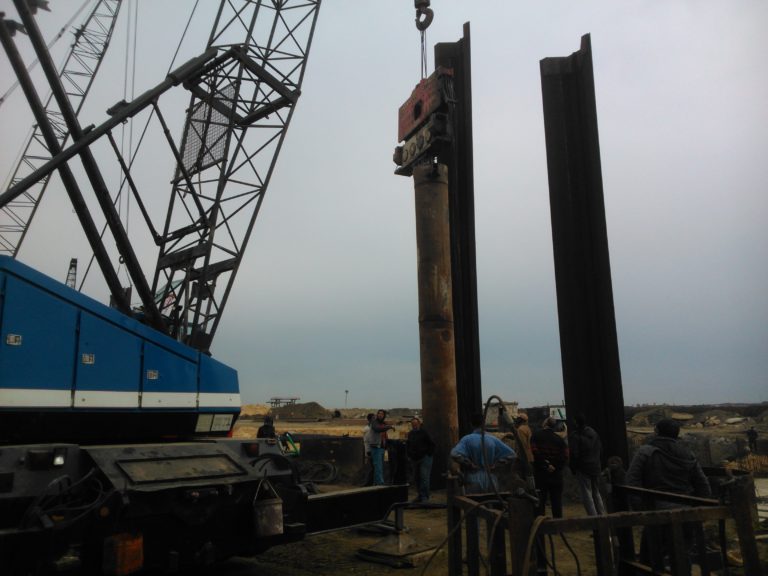 Steel pipe piles are under installation on water